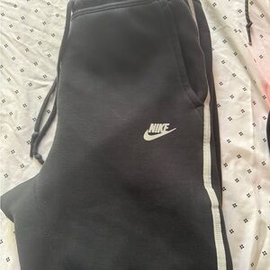 Two pairs of Nike Black Joggers with White Side Stripe and black and red